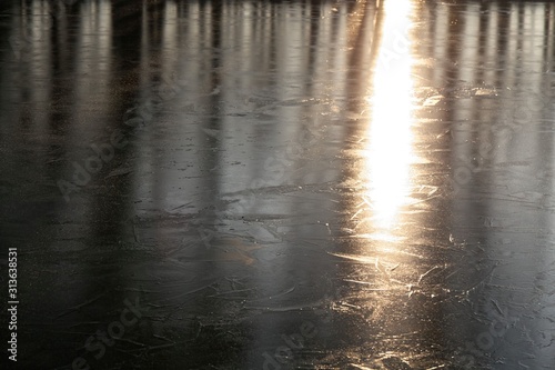 Light reflection on a frozen lake surface