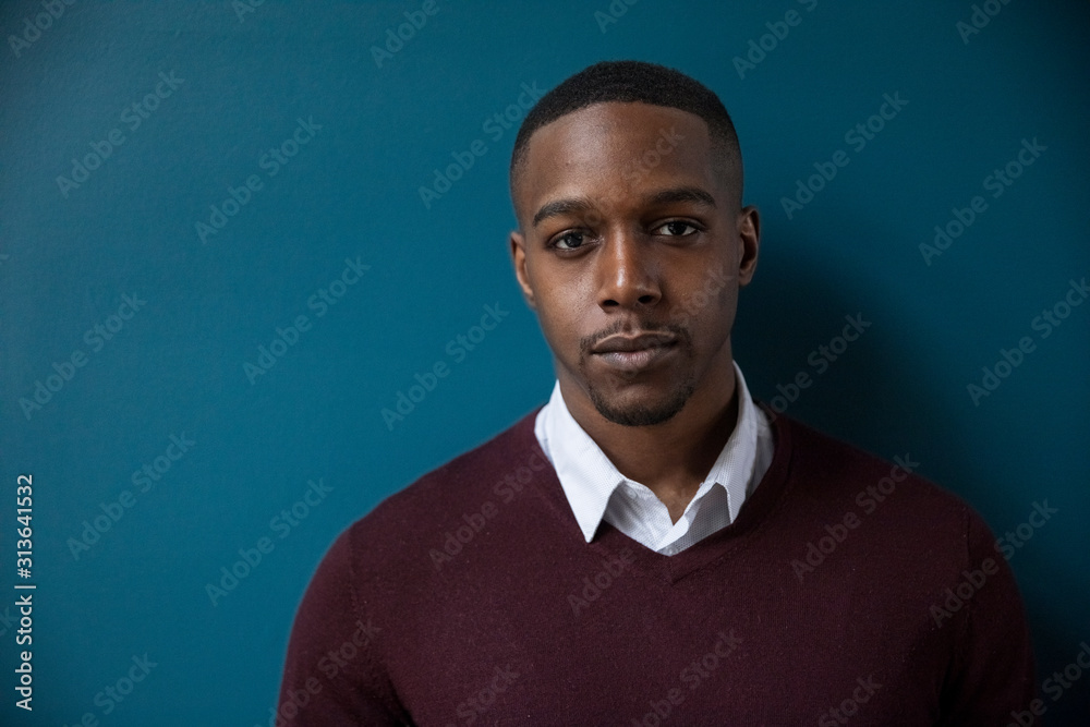 Fototapeta premium Close-up portrait of confident businessman standing against wall in darkroom at office