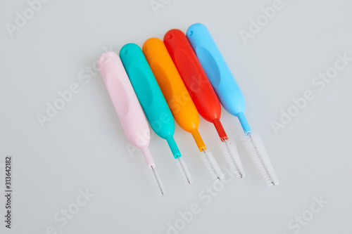 Brushes for braces, toothbrushes for interdental spaces on white background. Close up. Macro. The concept of good mouth hygiene. Different sizes of interdental / interproximal tooth brushes