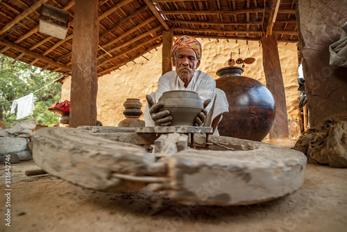Potter at work makes ceramic dishes. India, Rajasthan. photo