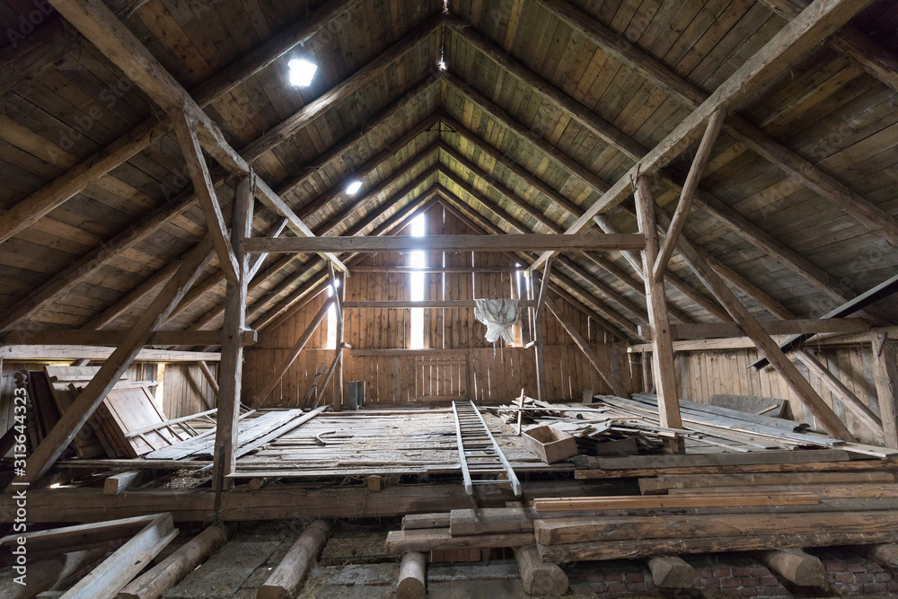 Old and dusty creepy wooden attic with roof framework structure of the old house Awesome horror attic