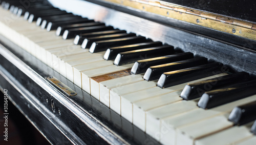 Old piano keyboard background with selective focus