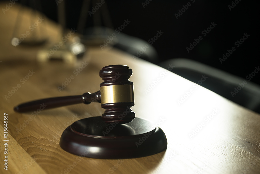 Law and Justice concept. Mallet of the judge, books, scales of justice. Gray stone background, reflections on the floor, place for typography. Courtroom theme. Law and Justice concept. Mallet of the judge, books, scales of justice. Gray stone background, reflections on the floor, place for typography. Courtroom theme.