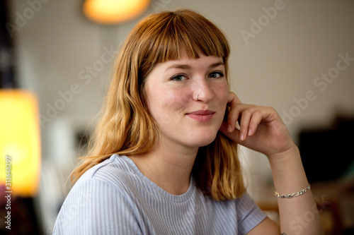 Portrait of strawberry blonde young woman with nose piercing photo