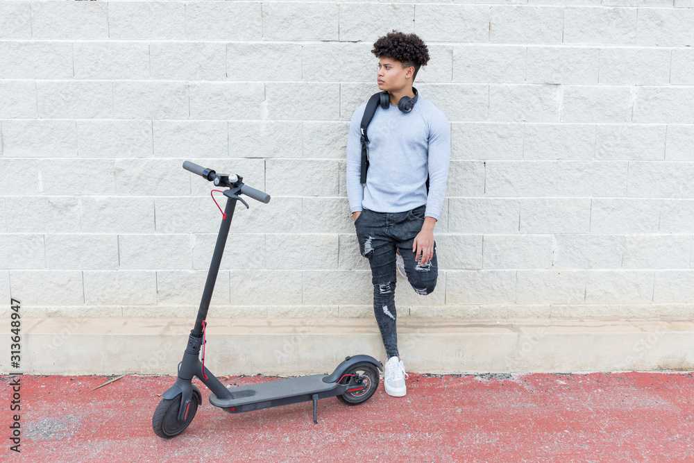 Young man with e-scooter outdoors Young man with e-scooter outdoors