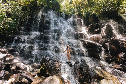 Young woman near Kanto Lampo waterfall, Bali, Indonesia