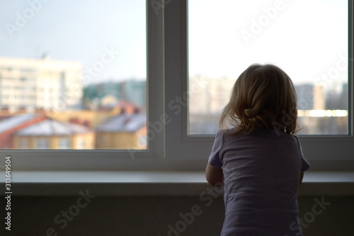 A little girl standing in front of a window Free Download A little girl standing in front of a window - GFXLoad