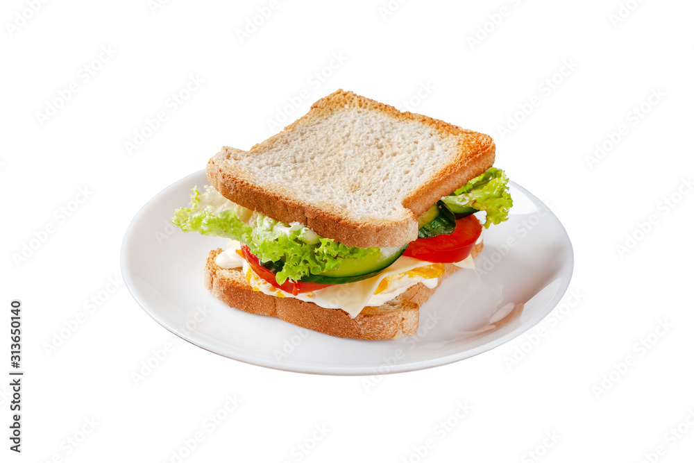 Homemade sandwich made of toast bread, fried egg, melted cheese, tomatoes, cucumber, lettuce, burgers and mayonnaise sauce. Sandwich on a white plate, on a black background. Homemade sandwich made of toast bread, fried egg, melted cheese, tomatoes, cucumber, lettuce, burgers and mayonnaise sauce. Sandwich on a white plate, on a black background.