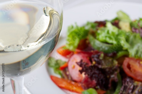  delicious fresh vegetable salad and a glass of white wine