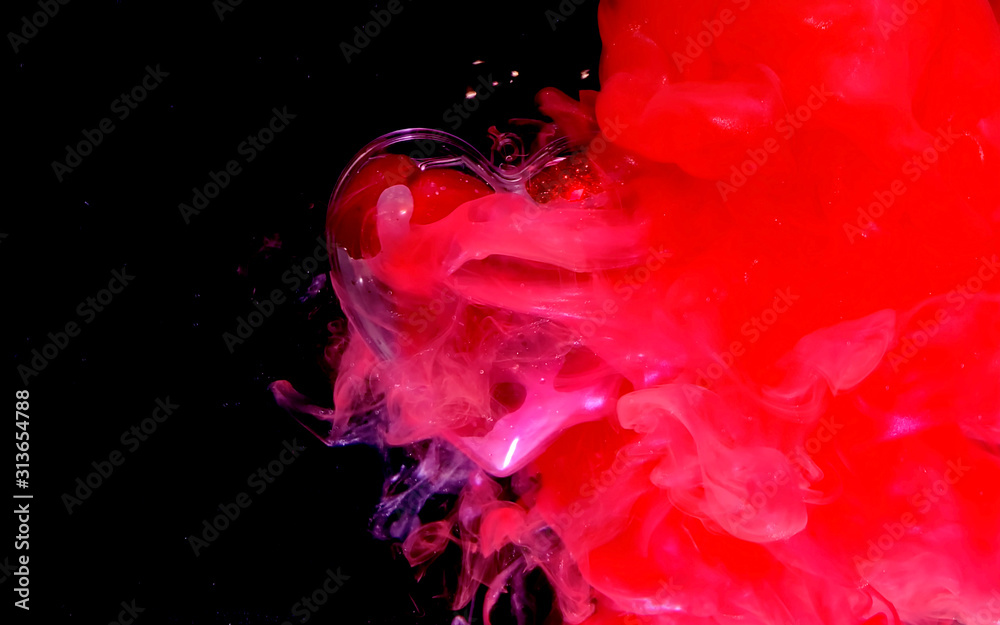 Beautiful glass heart with small red shiny hearts inside on a beautiful scarlet background.