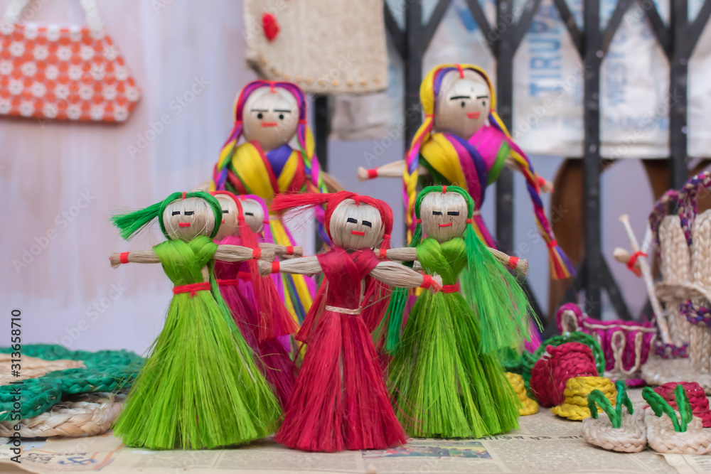 Colourful decorative wall hangings, dolls made of jute, handicrafts for sale (Selective Focus)