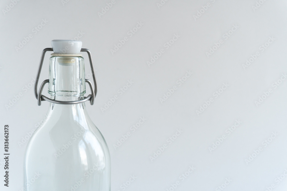 Glass bottle at gray backround. Zero waste concept.