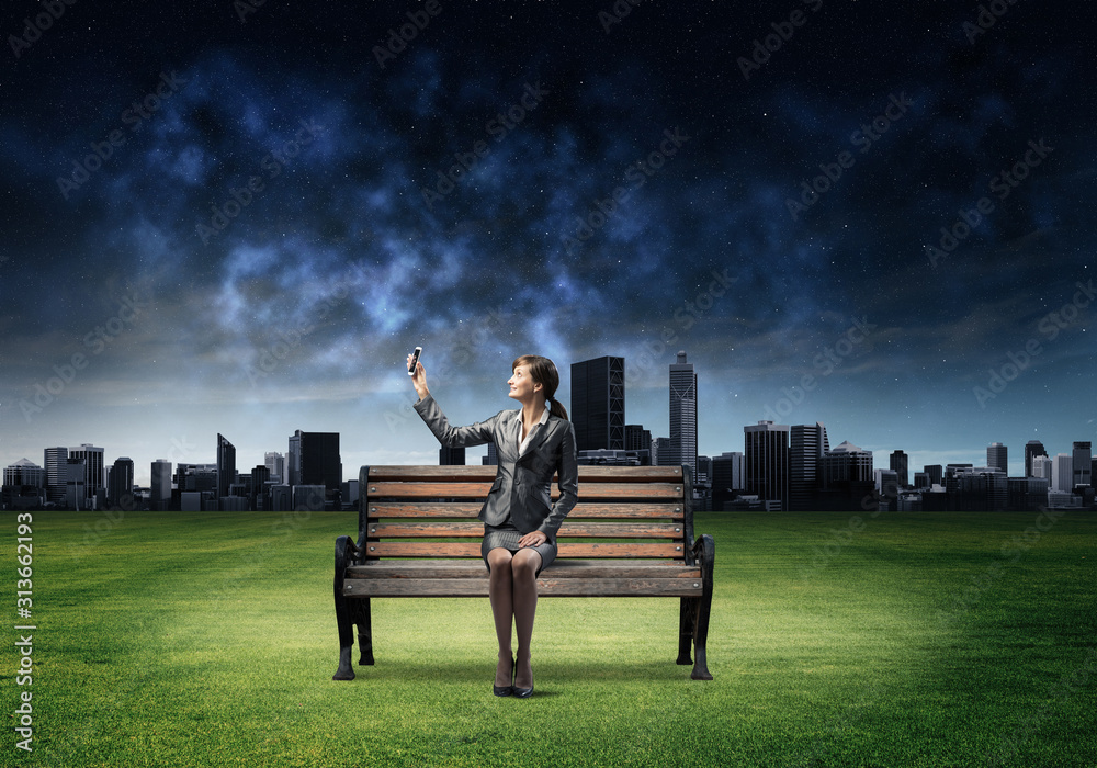 Young woman in business suit holding smartphone Young woman in business suit holding smartphone