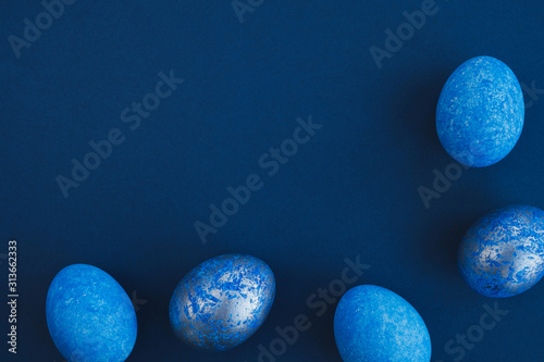Blue easter eggs painted by hand on a dark background. Easter stylish minimal composition. Top view, flat lay, copy space