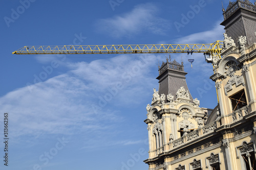 Construction Crane seen above Ornate Classical Building 