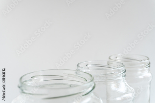 Glass jars at gray monochrome background. Zero waste concept.
