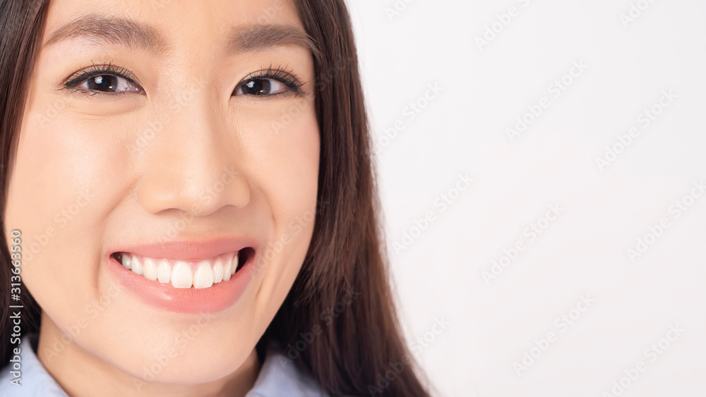 Close up of Asian woman with beautiful teeth on white background Close up of Asian woman with beautiful teeth on white background