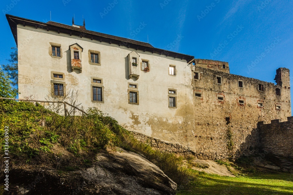 Landstejn, Czech Republic - September 29 2019: View of a medieval knights castle made of stone standing on a rocky hill. Bright sunny day with blue sky.