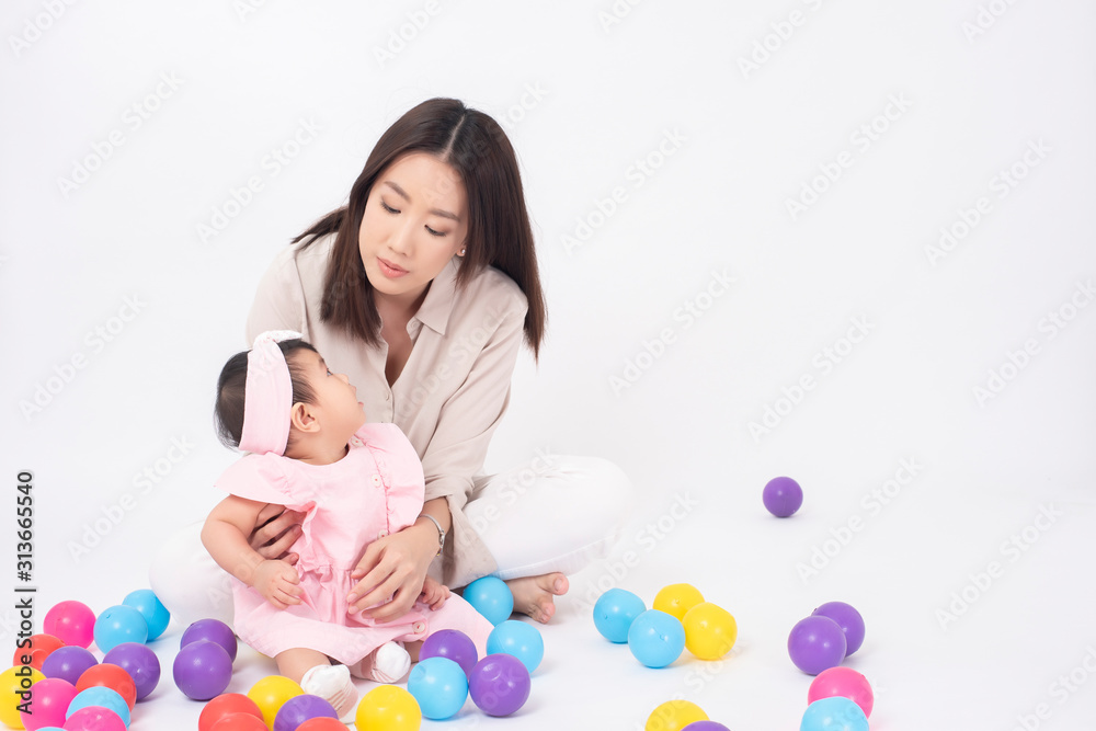 Asian mother and adorable baby girl are happy on white background Asian mother and adorable baby girl are happy on white background