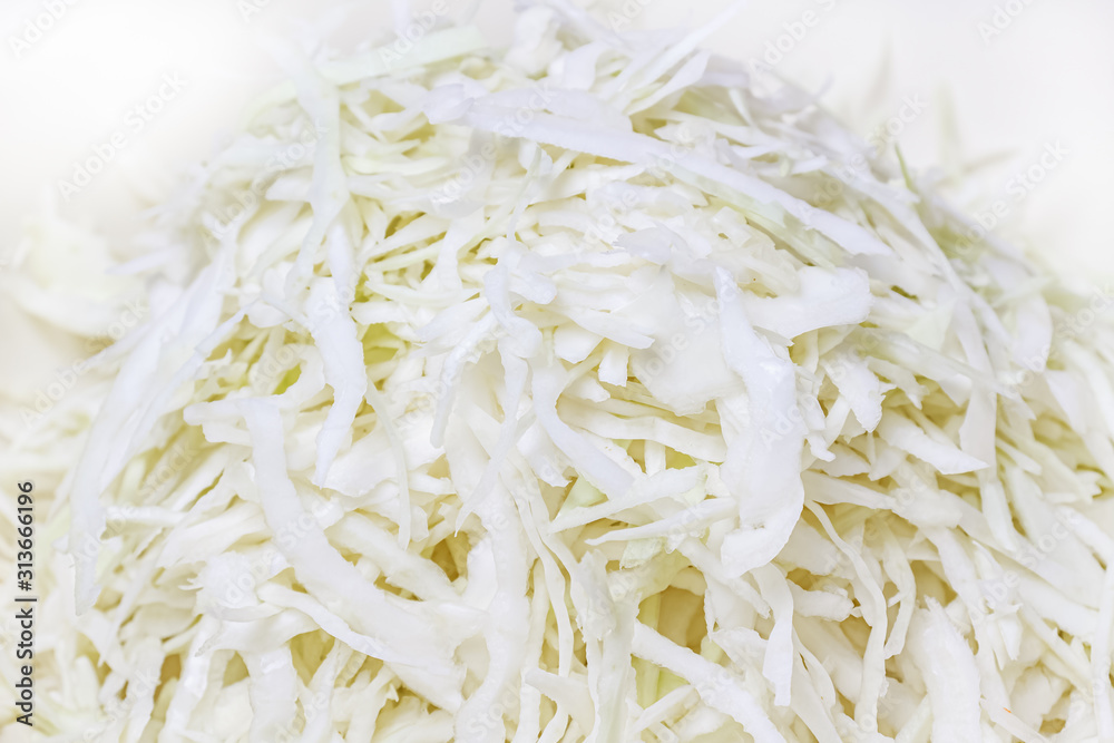 Fresh juicy chopped white cabbage in the metal bowl close-up Fresh juicy chopped white cabbage in the metal bowl close-up