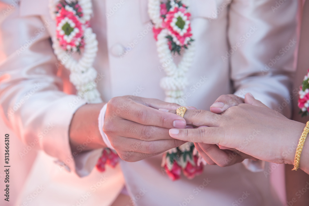Wedding ring.Groom put the wedding ring on bride.Thai traditional wedding ceramony decoration Wedding ring.Groom put the wedding ring on bride.Thai traditional wedding ceramony decoration