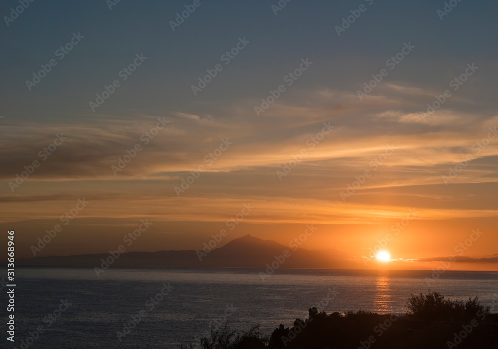 Beautiful orange sunrise over calm ocean and mountain pico del Teide at Tenerife seen from La Palma, Canary Island Beautiful orange sunrise over calm ocean and mountain pico del Teide at Tenerife seen from La Palma, Canary Island