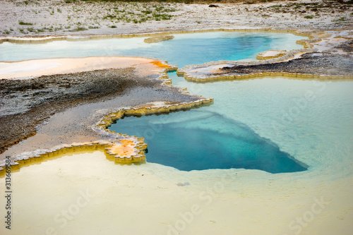 Doublet Pool features blue water and colorful sinter geyserite mats photo