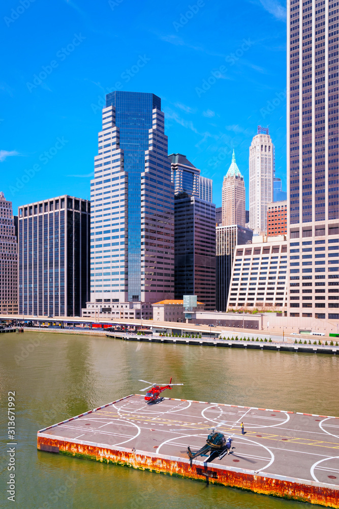 Fototapeta premium Helicopter landing at helipad. Skyline with Skyscrapers in Lower Manhattan, New York City, America USA. American architecture building. Metropolis NYC. Cityscape. Hudson, East River NY