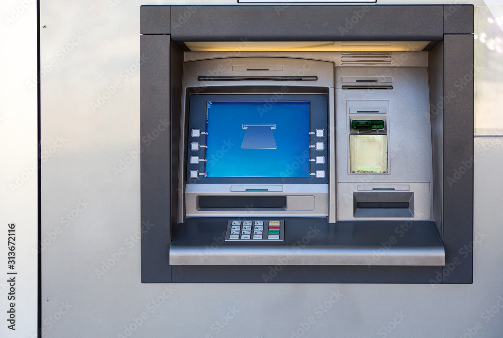 Silver atm machine with screen and buttons is in building wall, nobody  Stock Photo | Adobe Stock