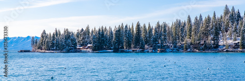 The Lake Tahoe in Nevada and California, panorama of a pontoon for mooring boats in winter, and houses on the shore