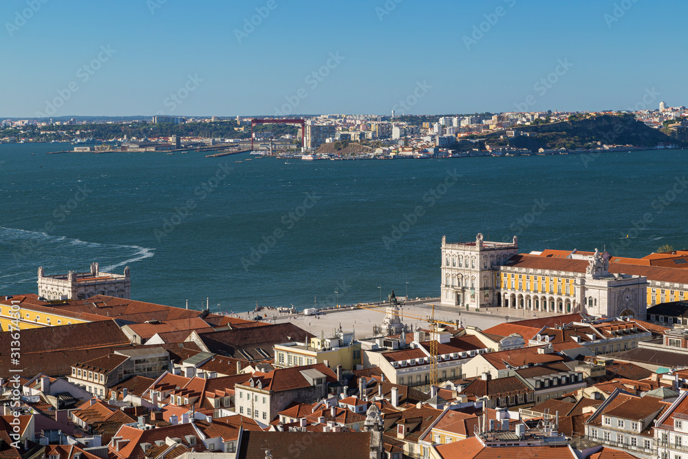 View of the historical Praca do Comercio and Alfama district in downtown Lisbon, Tagus River and Almada city from above in Portugal.