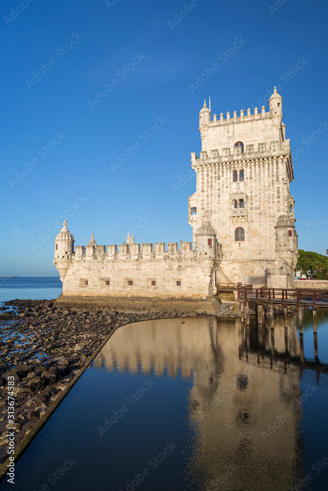 View of the historic 16th century Belem Tower (Torre de Belem) by the Tagus River in Belem district in Lisbon, Portugal, on a sunny morning.