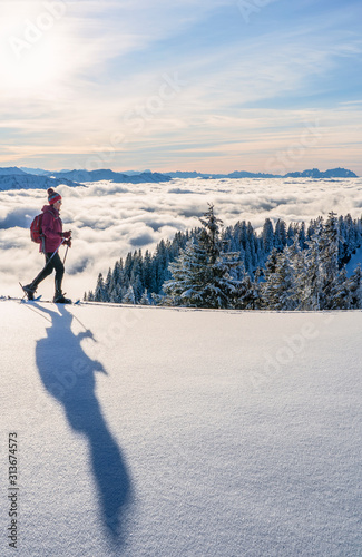 nice senior woman snowshoei...