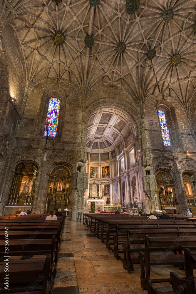 Few people at the main chapel of the Church of Santa Maria at Mosteiro dos Jeronimos (Jeronimos Monastery) in Belem, Lisbon, Portugal.