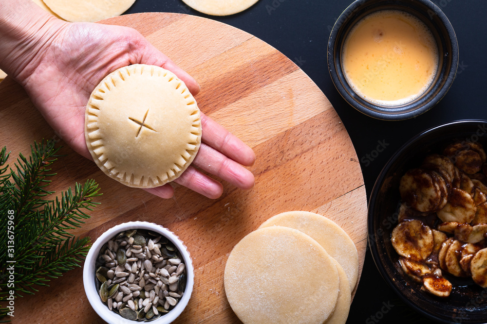 Food concept processing to make Homemade Banana foster hand pie on black background Food concept processing to make Homemade Banana foster hand pie on black background
