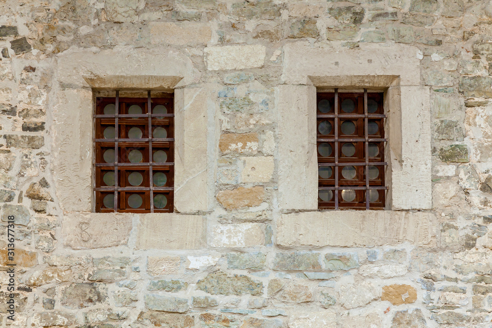 An old stone wall with windows