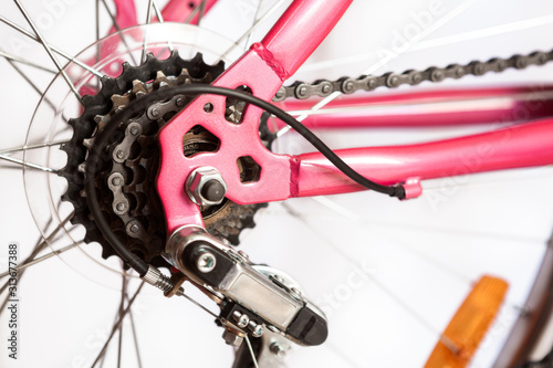 Rear mountain bike cassette on the wheel with chain, pink frame of bicycle, isolated on white background