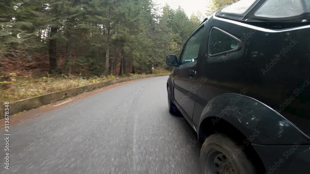 Point of view off-road car driving on a mountain road