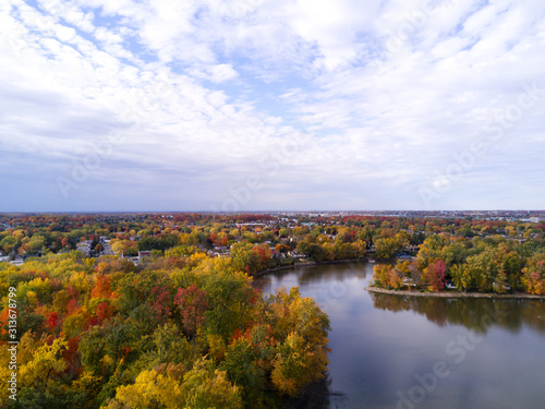 Aerial view taken with a drone of an autumn landscape with river