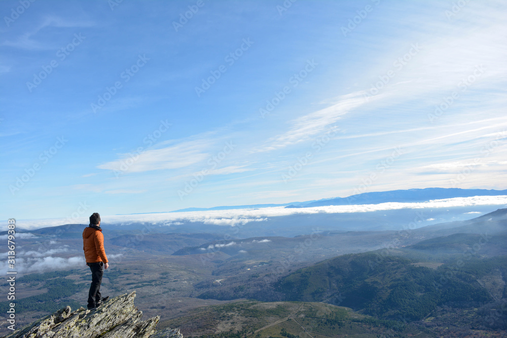  man observes the landscape from the top of the mountain . Peña de Francia, Salamanca, Spain. Space for text. Concept: freedom