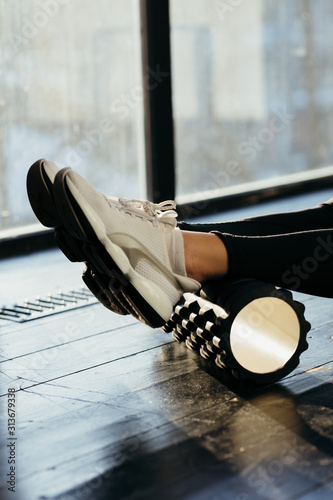 Woman Using Foam Roller for Muscle and Fascia Stretching