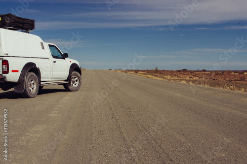 white car in desert on road