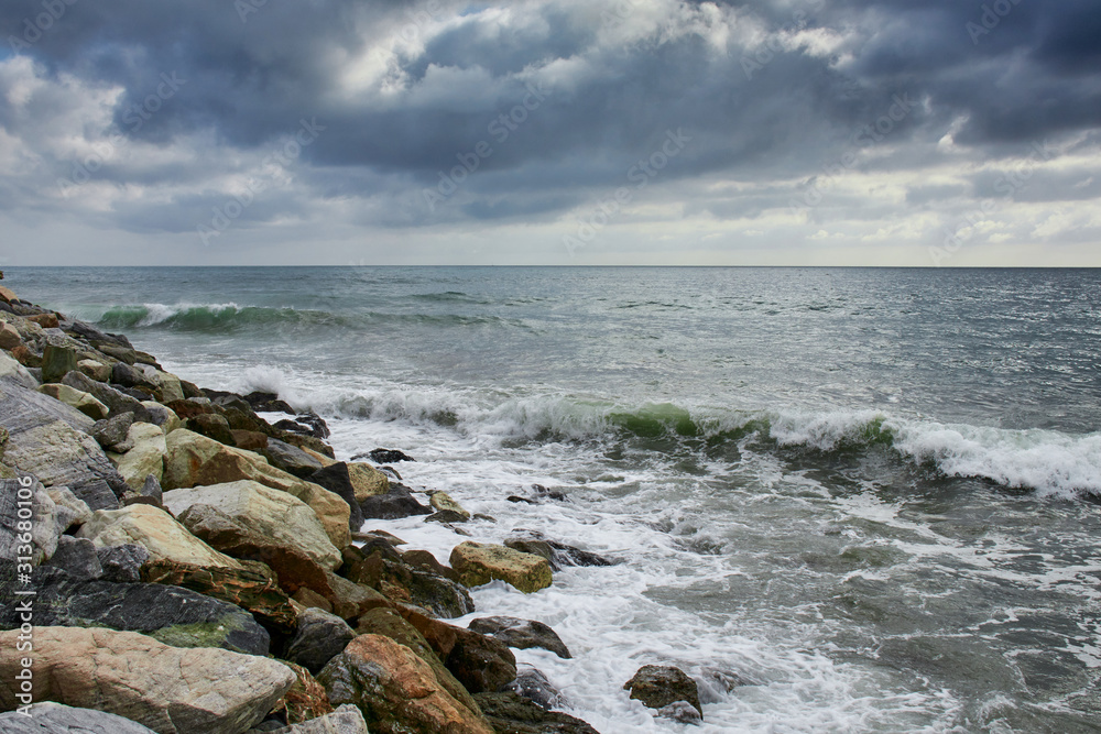 Cloudy day with waves hitting the coast