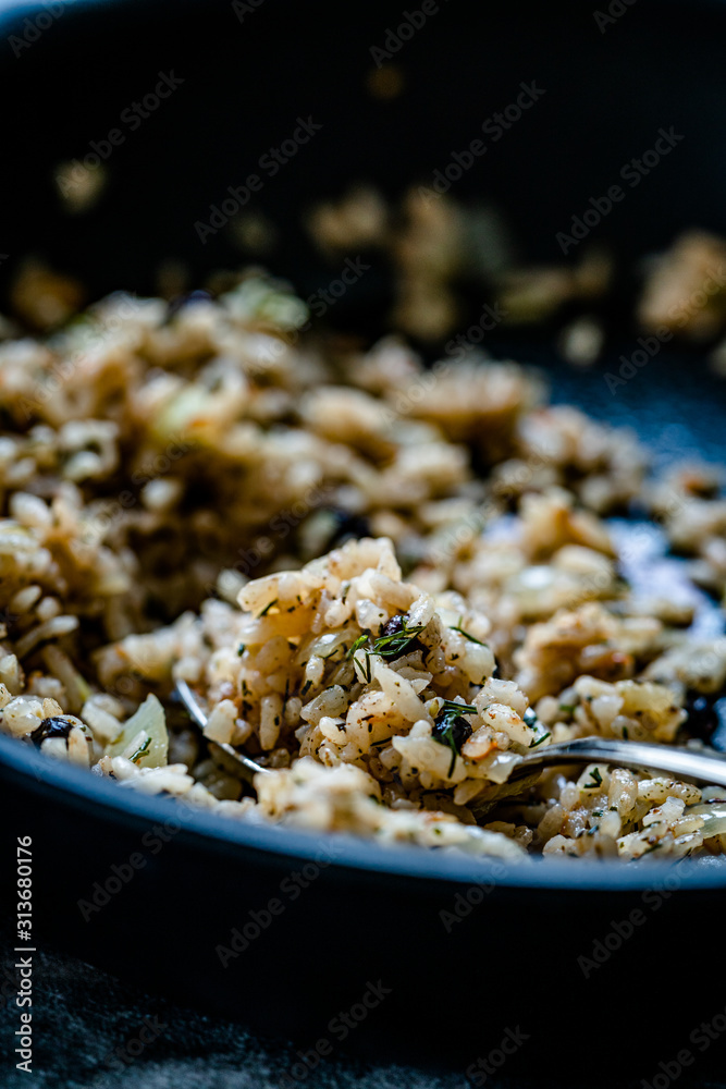 Turkish Stuffed Rice with Currants for Preparing Dolma in Pan with Spoon / Pilav or Pilaf Turkish Stuffed Rice with Currants for Preparing Dolma in Pan with Spoon / Pilav or Pilaf
