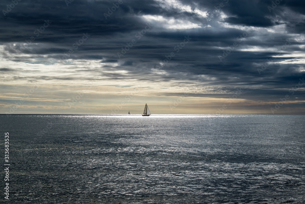 Sailboat at calm sea on midday, sailing boat in mediterranean sea