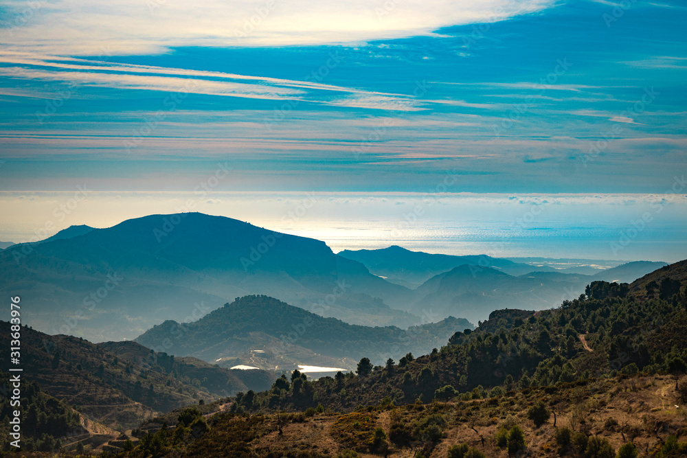 Nice landscape with a cloudy blue sky and mountains