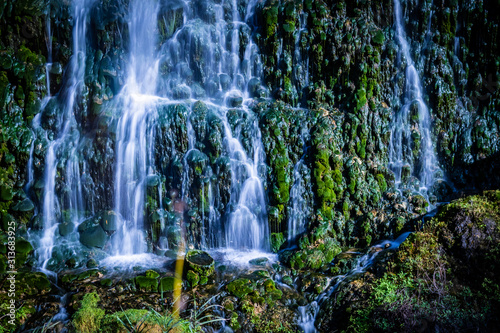 Waterfall on stones with vegetation and humidity