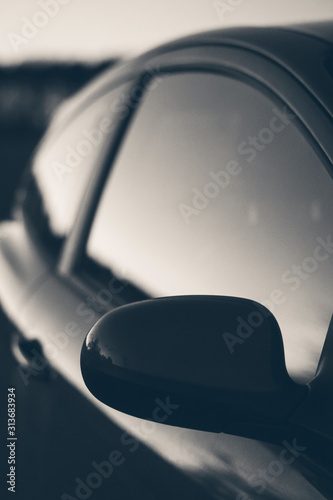Close up moody stylised black and white shot of a car window.