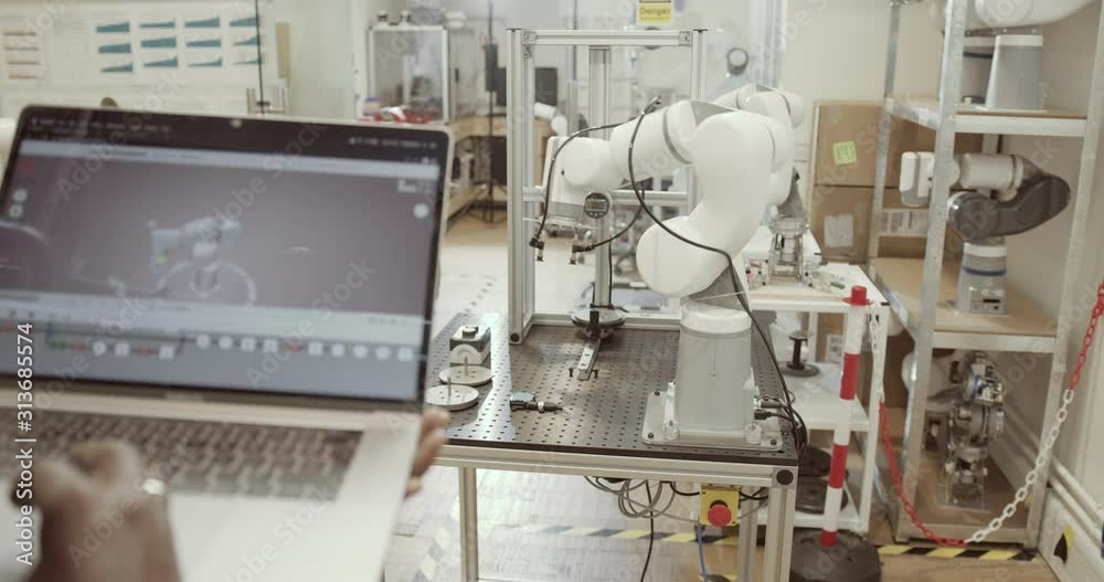 Engineer programming robotic arm