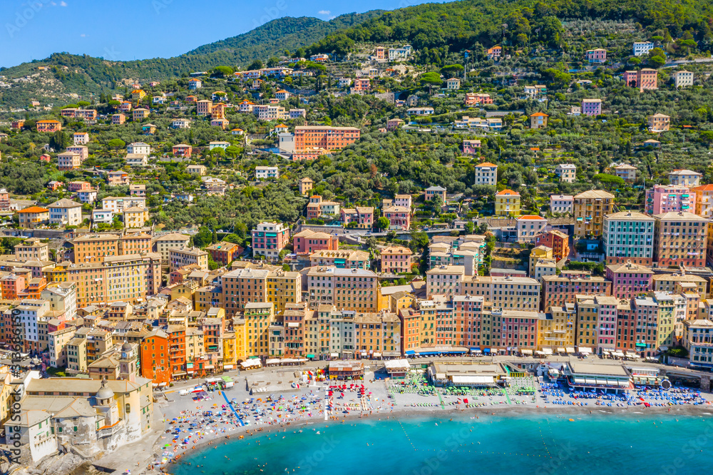 Aerial view of Camogli. Colorful buildings near the ligurian sea. View from above on the public beach with azure and clean water.